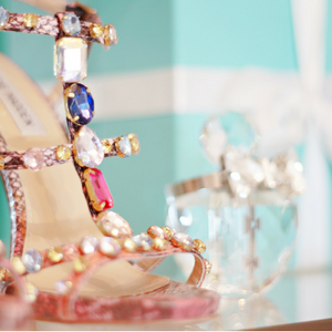 Image of jeweled shoe and crystal perfume container on the second shelf of the vanity section of customized unit by Closet Factory