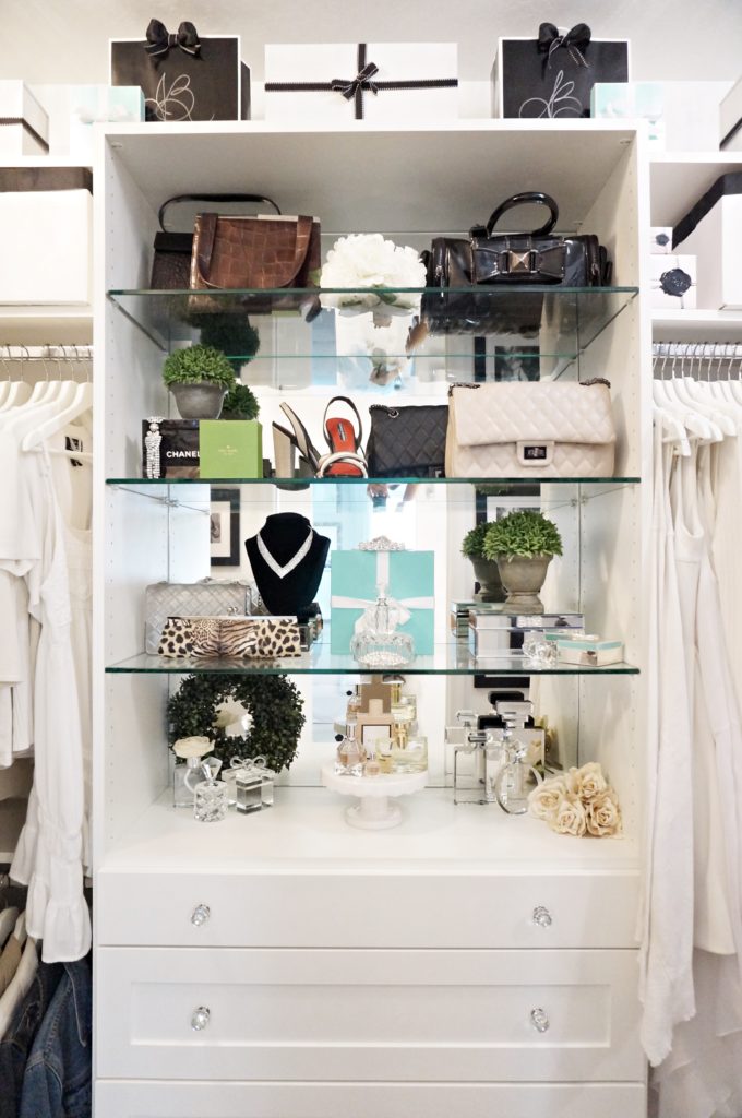 mirror-backed, glass shelves in master closet built-in